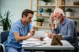 mature-man-feeling-concerned-while-talking-his-doctor-who-is-showing-him-medical-test-results-digital-tablet